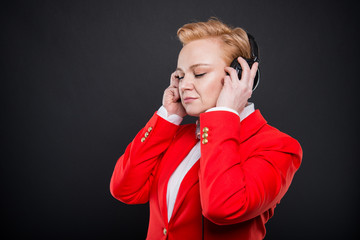 Portrait of attractive business woman wearing headphones enjoying music