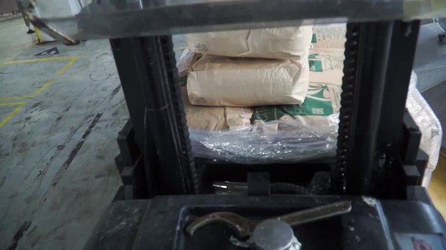 Electric forklift in warehouse loading cardboard boxes. Clip. Loading machine