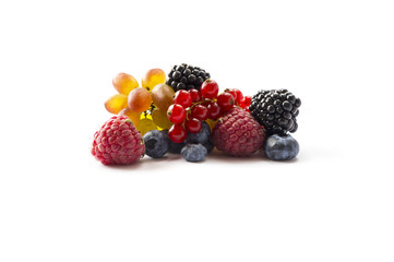 Mixed of fresh fruits and berries isolated on a white background. Ripe blueberries, blackberries, red currants, grapes, raspberries. Berries and fruits with copy space for text. Background berries.