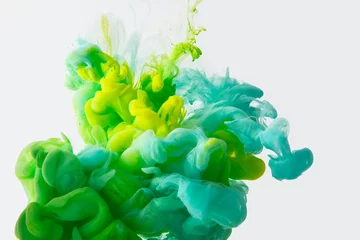 Fotobehang close up view of mixing of green, yellow and bright turquoise paints splashes in water isolated on gray © LIGHTFIELD STUDIOS