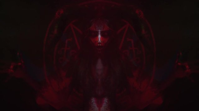 The magician in the image of the devil reads spells, body painting