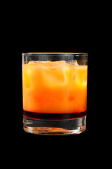 Multi-colored two-layer opaque cocktail in a low glass with ice cubes with melon, pear, apple, berries, fruit, pineapple, orange, apricot, peach. Side view Isolated black background Drink for the menu