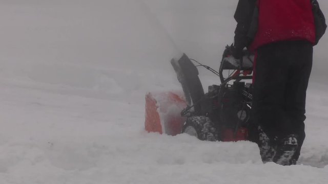 snowblowing in the winter blizzard slow motion