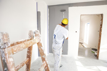 Room painter painting new home - obrazy, fototapety, plakaty