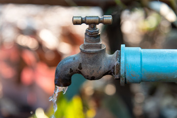Close up Faucet and Water Drops fall