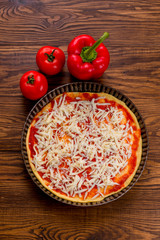 Fresh original Italian raw pizza, preparation in traditional sty