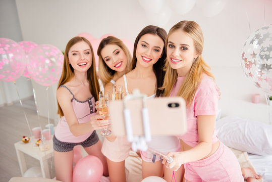 Pretty sexy charming stylish attractive cheerful group of girls enjoying meeting in house, indoor celebrating sleepover holiday event birthday shooting self portrait on front camera using smart phone