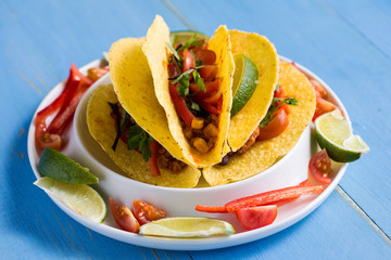 Mexican Tacos with Ground Beef and Vegetables on Rustic Blue Background