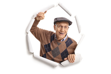 Elderly man breaking through paper