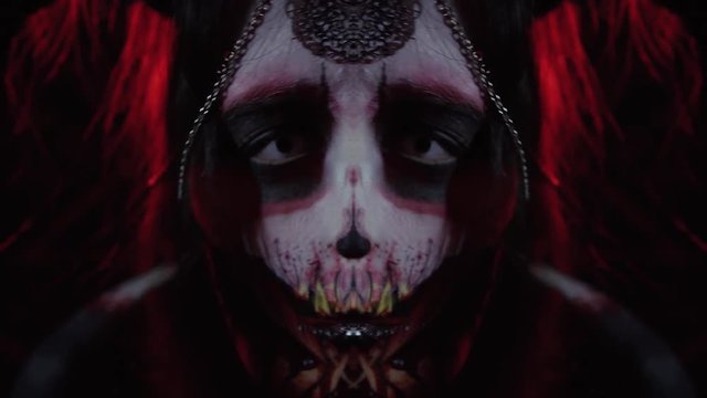 A girl in the image of a demon dances in front of the camera in a ritual dance, montage