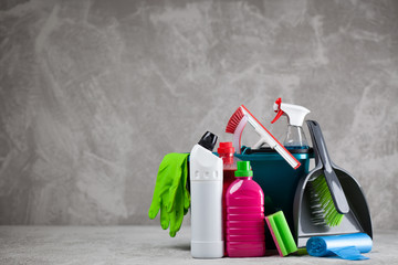 Cleaning supplies on grey background