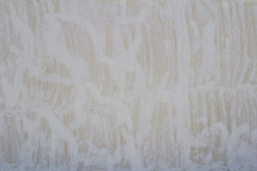 close up white paint glue on yellow aged sandstone brick wall