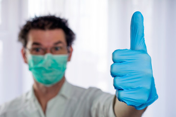 arrogant strange looking doctor shows thumb up gesture