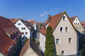 red tiled roofs of the ancient German city Dinkelsb&uuml;hl against the blue sky