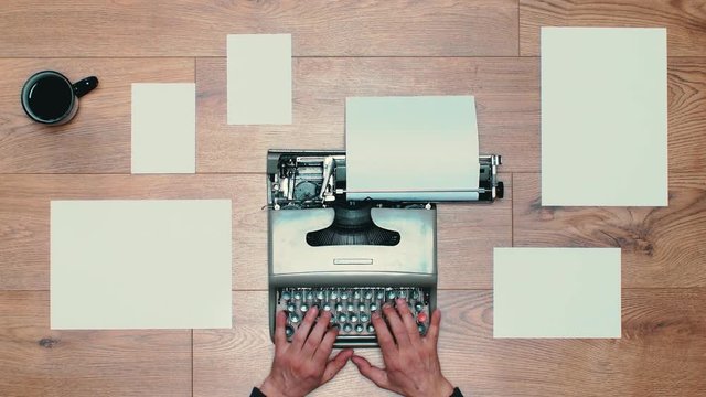Book writing by the window with a vintage typewriter. 4K video colors and black and white