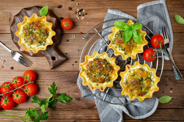 Baked homemade quiche pie in mini metal forms