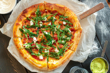 delicious italian pizza served on wooden table top view