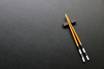 wood chopsticks on black table background