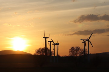 Wind power station in sunset. Romantic evening and modern technologies of ecologically clean...