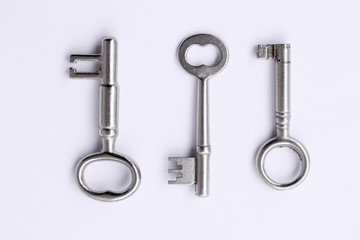 Metallic house silver keys on white background