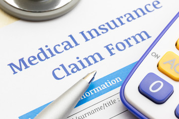 Medical insurance claim form, Stethoscope, pen and calculator symbol for health care costs or medical insurance