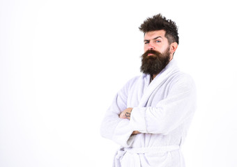 Man with beard and mustache standing with crossed arms, isolated on white background. Macho in...