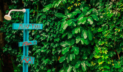 Board signaling muay-thai, yoga and açai. This photograph was taken in Matinhos,Paraná, Brazil, 2018.