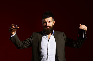 Partying and drinking concept. Man holding glass of whiskey