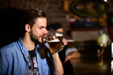 Man drink beer sitting in bar. Party and celebration concept