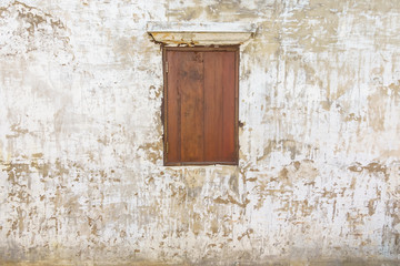 Old grunge wall with wooden window