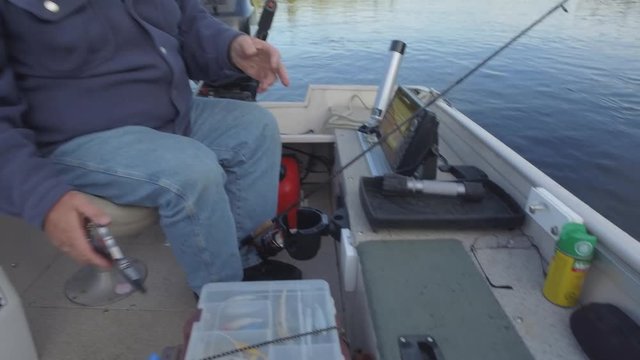 fisherman puts his walleye into live well 4k gimbal