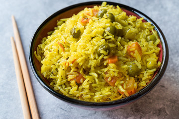 Yellow Saffron Basmati Rice with Turmeric  and Vegetables Pilav or Pilaf in Bowl with Chopsticks.