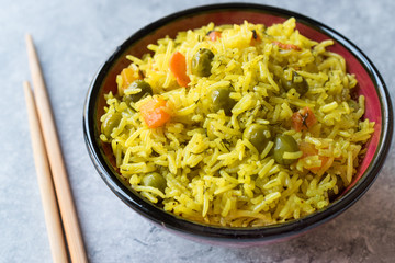 Yellow Saffron Basmati Rice with Turmeric  and Vegetables Pilav or Pilaf in Bowl with Chopsticks.