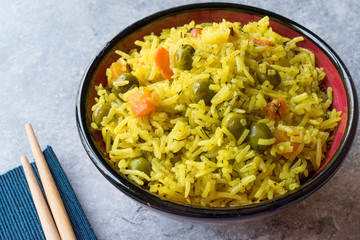 Yellow Saffron Basmati Rice with Turmeric  and Vegetables Pilav or Pilaf in Bowl with Chopsticks.