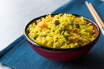 Yellow Saffron Basmati Rice with Turmeric  and Vegetables Pilav or Pilaf in Bowl with Chopsticks.