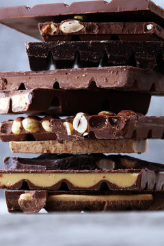 Chocolate bars on table with chocolate tower.