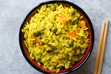Yellow Saffron Basmati Rice with Turmeric  and Vegetables Pilav or Pilaf in Bowl with Chopsticks.