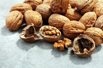 Walnut kernels and whole walnuts on rustic old table