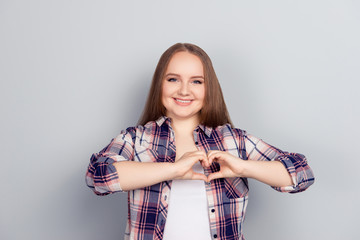 Young woman making heart shape with her hands