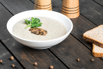 A bowl of mushroom soup cream on the table