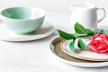 ceramic tableware with flowers on white background