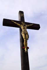 Bronze sculpture of Jesus Hristos crucified on a wooden cross. Jesus Christ is a symbol of...