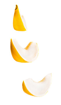 set of melon slices hanging in the air isolated on white background