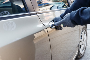Male thief tries to steal a car. Car theft concept