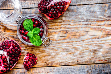 sliced pomegranate on wooden background top view