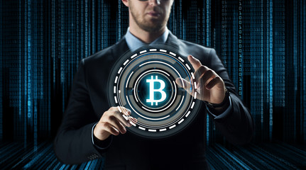 cryptocurrency, financial technology and business concept - close up of businessman with virtual bitcoin symbol hologram over and binary code and black background