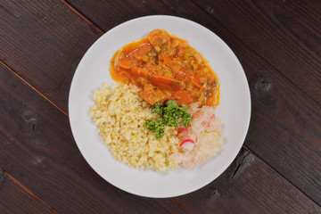 Seitan goulash with bulgur on a table