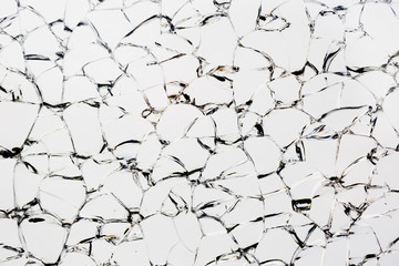 Detail of broken tempered glass pane too many small irregular shape pieces holding together resembling puzzle desktop. Focused on whole plane with sharp details and beautiful chip edges rainbow effect