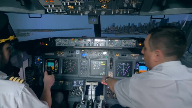 Pilots control in a flight simulator.