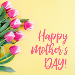 Happy Mother's day card with armful of pink tulips on yellow background.